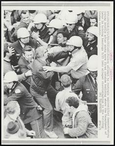 Chicago: Police attempt to restrain unidentified demonstrators during scuffle after shots were fired outside building where the Department of Labor is holding hearings 9/25 into alleged discrimination in the building trades industry.