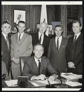 CPA Officials look on as Secretary of State Kevin White signs charter establishing new Educational Foundation sponsored by Massachusetts Society of Certified Public Accountants. Standing, from left, Thomas Brew, Wellesley, vice president; Robert M. Kitchin, Sudbury, director; Morris Goodman, Brookline, president, and Robert Boyer, Newton, vice president.