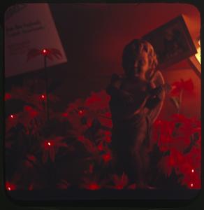 Figurine of an angel surrounded by lit flowers