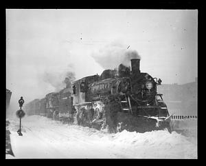 Train steaming through snow