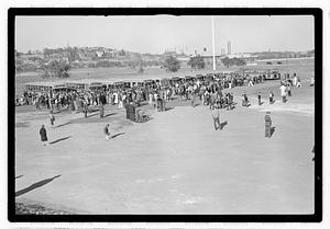 A crowd of people gathered by buses
