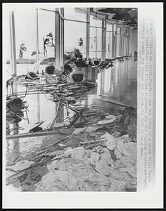 This was the lobby of a swank Miami Beach bar front hotel. Then Cleo hit, she deglassed the 200 ft. long window, undraped the drapes; up turned the tables and chairs. She left it in a mess.