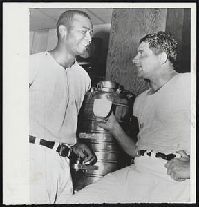 Time For Relaxation -- Larry Doby (left) and Earl Wynn of Indians visit over coffee in dressing room after victory over White Sox. Doby hit pair of home runs and Wynne hit game.