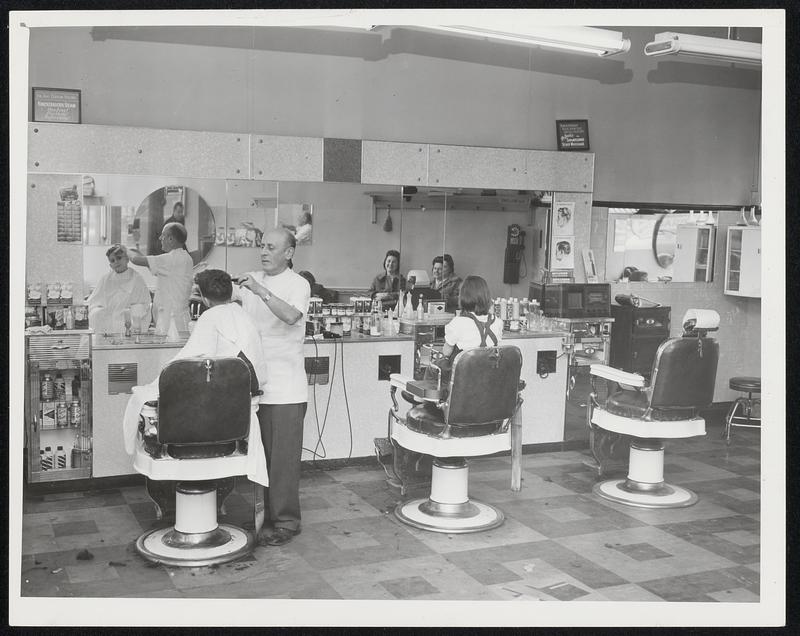 Blue Hill Barbershop L to R Barber giving Stewart Michelson -6 1/2 of 5 Jones Ave. Hov. Haircut - Barber is Mey Leshgold. Gail Davis - 5 is sitting in chair, she is from Woodbale Ave Mattapan.