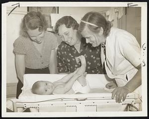 Tapped for Immortality - Members of the Royal Fraternity of Master Metaphysicians Nov. 24 admired Baby Jean (above), five months old, whom they have selected for an experiment which they believe may make the baby immortal. Baby Jean, daughter of indigent parents, will be provided an environment, in the Vanderbilt mansion in Oakdale, N.Y., free of word or thought of death or disease in her quest for immortality. Shown with the baby are fraternity members Eleanor Shehr (left), Charlotte Schmidt (center) and Louisa Kerfs.