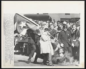 Fracas Over Cuban Flag- A pacifist marcher is downed as New York police move to restore order after a bystander, left, snatched a Cuban flag away from him during a protest demonstration on Fifth Avenue Saturday. The clash was one of a number between hecklers and marchers protesting the war in Vietnam as part of an organized three day protest being conducted in various cities across the nation. Some 10,000 marchers took part in the New York parade.