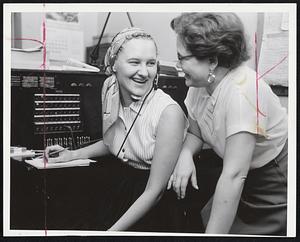 Keeping the Governor Posted on the course of Hurricane Edna yesterday were relief operators Rita Stakutis, left, of South Boston, and Mrs. Ruth Mundy, of Brighton. They relayed weather reports directly to Gov. Herter.