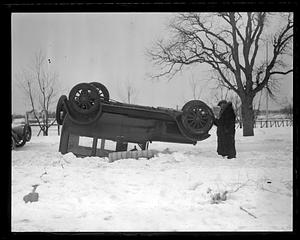 A car on its roof in the snow