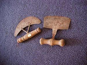 Two metal chopping tools with wood handles