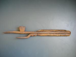 Rusty metal tool with wooden handle