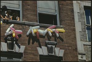 Balloons under windows on brick wall, North End, Boston