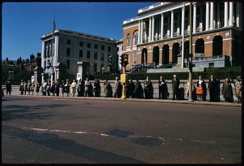 Row of people with signs on sidewalk in front of Massachusetts State House, Boston