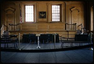 Room interior with rope barrier, American flag, and classical-style woodwork