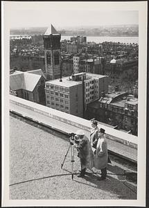 Surveying crew on roof of New England Life Building