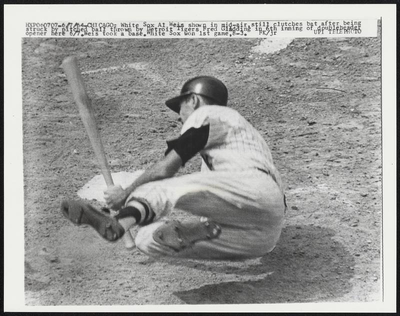 White Sox At Weis shown in mid-air, still clutches bat after being struck by pitched ball thrown by Detroit Tigers Fred Gladding in 6th inning of doubleheader opener here 6/7. Weis took a base. White Sox won 1st game, 8-3.