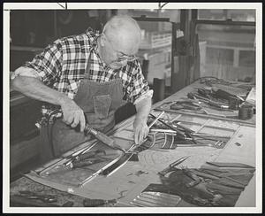 Molding Lead Edges around glass bits is Arthur Acker of Waltham, a craftsman for 57 years.