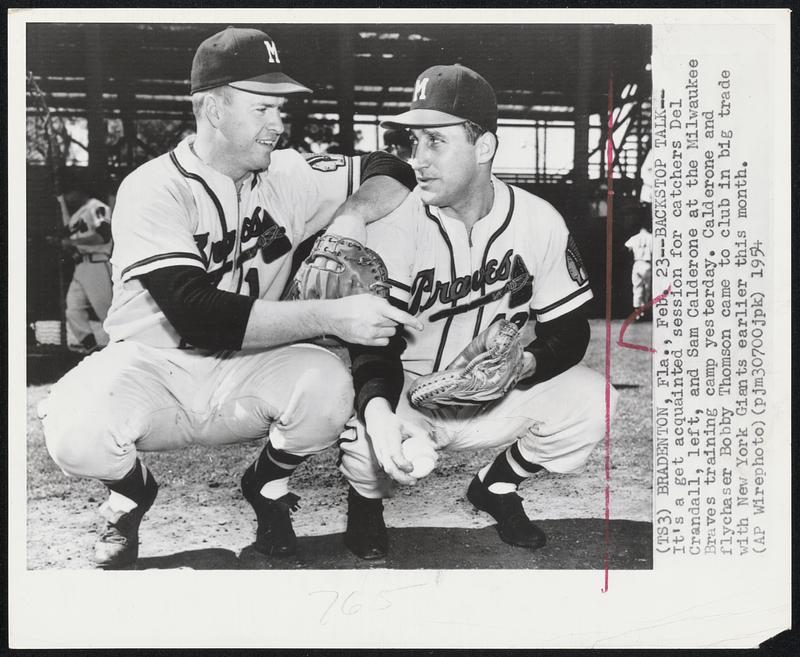 Bradenton, Fla. – Backstop Talk – It’s a get acquainted session for catchers Dell Crandall, left, and Sam Calderone at the Milwaukee Braves training camp yesterday. Calderone and flychaser Bobby Thomson came to club in big trade with New York Giants earlier this month.