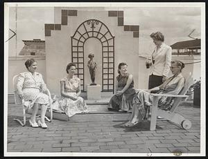 Cool Rooftop of the Franklin Square House, now refurbished, is enjoyed by Mrs. A. C. Ockenden, executive director, Miss Claude Turlin of France, Elaine McKenzie of Denver, Eleanor Kelly of New York, and Anne Petersen of Pawtucket, from left.