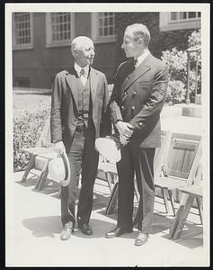 Secretary of Navy Commissions Son. Charles Francis Adams, secretary of the Navy, talking his son, Ensign Charles Francis Adams, Jr., after he had commissioned the younger Adams at Cambridge, Mass., June 23, after the Harvard commencement. Ensign Adams was a member of the third graduating class of the Harvard Unit of the Naval Science Department.