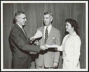First Prize Check for winning design of a beverage napkin being presented to Miss Jane Pierce of Framingham by Ralph L. Hanley, left, art director of the Erving Paper Mills of Erving, Mass. In center is Fletcher P. Adams, president of the Vesper George School of Art, where Miss Pierce is a student.