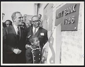 Roxbury First - With Mayor Kevin White in attendance, the first bi-racial bank in the history of New England holds ground-breaking ceremonies at 416 Warren St., Roxbury. Shown with White are Donald Sneed, president of the Unity Bank and Trust Co. and his granddaughter, Renee Johnson, who pulled back the bunting exposing the metal placque identifying the bank.