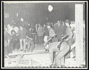 Penn State students throw rocks at State Troopers who were called on campus to clear Old Main of demonstrators. Twenty nine students were arrested. Eight police were injured. The students threaten to stage another demonstration (4/16) at noon.