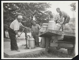 Water For Thirsty Cattle. His wells dried by the drought that has rolled up new losses in the Northeastern States, farmer Thomas C. Sanderson of Vernon Township, near Mountain Lakes, N.J., goes to the township pump for water for his thirsty cattle. He is here shown July 22 pumping water into cans to be hauled to his farm.