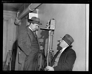 Two unidentified men speaking to each other