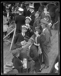 A group of people looking up from the deck of a ship