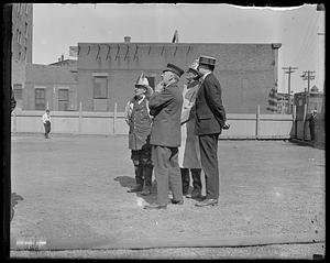 Four unidentified men, some wearing firefighter's uniform