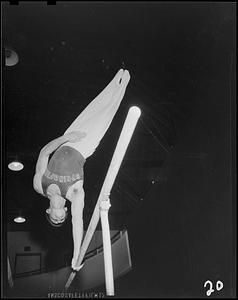 SC gymnast swinging on a parallel bar