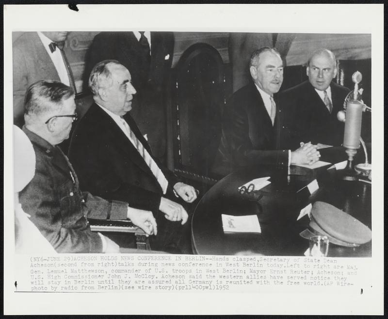 Acheson Holds New Conference in Berlin--Hands clasped, Secretary of State Dean Acheson (second from right) talks during news conference in West Berlin today. Left to right are Maj. Gen. Lemuel Matthewson, commander of U.S. troops in West Berlin; Mayor Ernst Reuter; Acheson; and U.S. High Commissioner John J. McCloy. Acheson said the western allies have served notice they will stay in Berlin until they are assured all Germany is reunited with the free world.