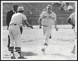 Roundtripper - East Boston catcher Mario Oliveri crosses plate after belting solo home run in ninth inning vs. South Boston.