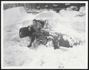 Trapped Texan -- Rod Mitchell, a Texan, found out yesterday that snowflakes are bigger in Boston as he set out to dig out his little sports car from a noble Boston drift on Beacon street at Arlington.