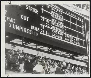 St. Louis Scoreboard Tells Story and it is not a happy ending for Cardinal rooters. As denizens of the bleachers at Sportsman’s Park wave, figures above them show that Brooklyn’s Dodgers took it on chin and the Cubs lead the Redbirds, 6-2, going into eight inning. Cubs went on to win, 8-3, leaving pennant race tied up and forcing a play-off between Cards and Brooks.