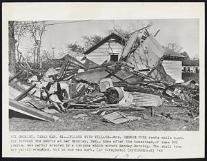 Cyclone Hits Village-Mrs. George Funk rests while hunting through the debris at her Hockley, Tex., home after the homestead, of some 300 people, was partly wrecked by a cyclone which struck Monday Morning. The small town was partly wrecked, but no one was hurt.