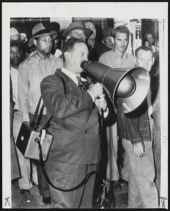 Sorrell Addresses Movie Strikers- Herbert Sorrell, president of the Conference of Studio Unions, uses a portable voice amplifier to address pickets at Warner bros. studio, one of seven picketed in a new strike today. He explained he was using the portable outfit because of an ordinance prohibiting use of sound trucks.