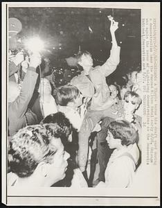 Chicago: A Yippie burns his draft card during a demonstration near the Conrad Hilton Hotel early 8/28. Chicago was again the scene of night-long demonstrations as the Democratic National Convention met.