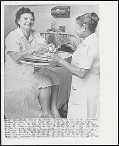 Pounds Lighter, She Gets to Eat Again--Mrs. Elaine Johnson, the 39-year-old Culver City, Calif. housewife who has been fasting for 117 days, is served her breakfast at Wadsworth Veterans Hospital in Los Angeles today--a pair of hardboiled eggs. Mrs. Vera Brown of the hospital staff does the serving. Mrs. Johnson lost 136 of her 315 pounds during the fast, which ended on Friday when she had her first meal since Jan. 28. It consisted of a spoonful of cottage cheese and about a quarter of a cup of eggnog. "I couldn't eat it all--it was too much," Mrs. Johnson told newsmen.