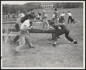 Keep That Log Up -- The Middlebury team of five men is trying to cut time as well as the log in the cross-cut sawing event. Results are based on speed.
