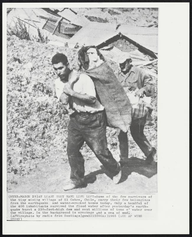 At Least They have Life Left -- Some of the few survivors of the tiny mining village of El Cobre, Chile, carry their few belongings from the earthquake and water-wrecked homes today. Only a handful of the 400 inhabitants survived the flood water after yesterday's earthquake burst a 230-foot-high dam and set millions of tons of water over the village. In the background is wreckage and a sea of mud.