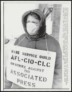 Associated Press photographer Paul Shane donned a face mask as he picketed in front of the Milwaukee bureau in near zero weather 1/9. Members of the Wire Service Guild went out on strike in a dispute over wages and a form of guild shop.