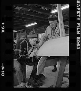 Ralph Johnson and Pert Lowell working in boat shop
