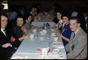 Group of people at table eating and drinking
