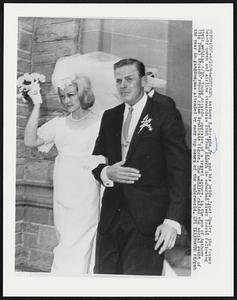 Anthony R. Accardo, Jr., and his bride, Janet Hawley, the former beauty queen and airline stewardess rush from church in suburban River Forest following their wedding 6/10. Young Accardo, operator of a travel agency, is the son of Anthony (Big Tuna) Accardo reputed crime syndicate figure. The wedding called the social event of the year in gangdom, was attended by many top names of the underworld.