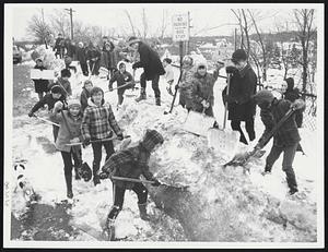 Weather Snowstorm 2/24/69 Youngsters of James J. Chittick School in Hyde Park clean up snowpile on River St. overpass, Mattapan, organised by Mrs. Jos. Polonski and Mrs. Robert Woods ca. 70 children started out at 10 AM, were still shoveling at 1PM