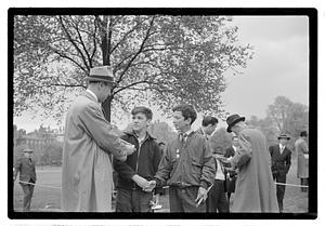 Two boys, both wearing medals, shaking hands