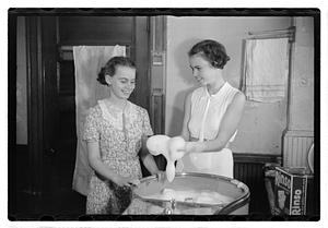 Women doing laundry with a washing machine