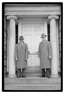 Two men standing in front of a door with a sign, "City of Boston Park Department"