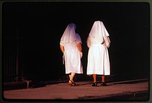 Boston 1984: Two nuns in white walk down a street in the Brighton section of the city
